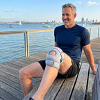 a man wearing patellapro while sitting on a bench at a baywalk